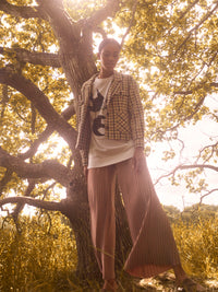 pleated pant in neutral based metallic beige gold. flare wide leg pant in flowing fabric, teamed with white tee and houndstooth jacket.