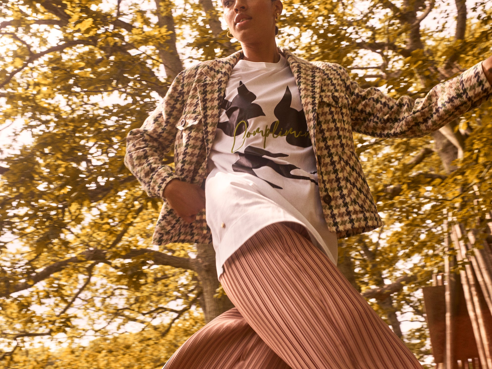pleated pant in neutral based metallic beige gold. flare wide leg pant in flowing fabric, teamed with white tee and houndstooth jacket.