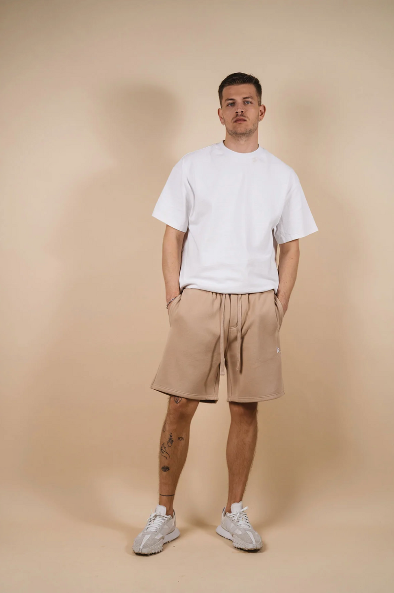 kore studios mens loose fit fleece track shorts with drawcord in tan taupe colour with white tee front