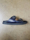 navy metallic leather womens slide sandal with silver hardware, studs and rivets side view