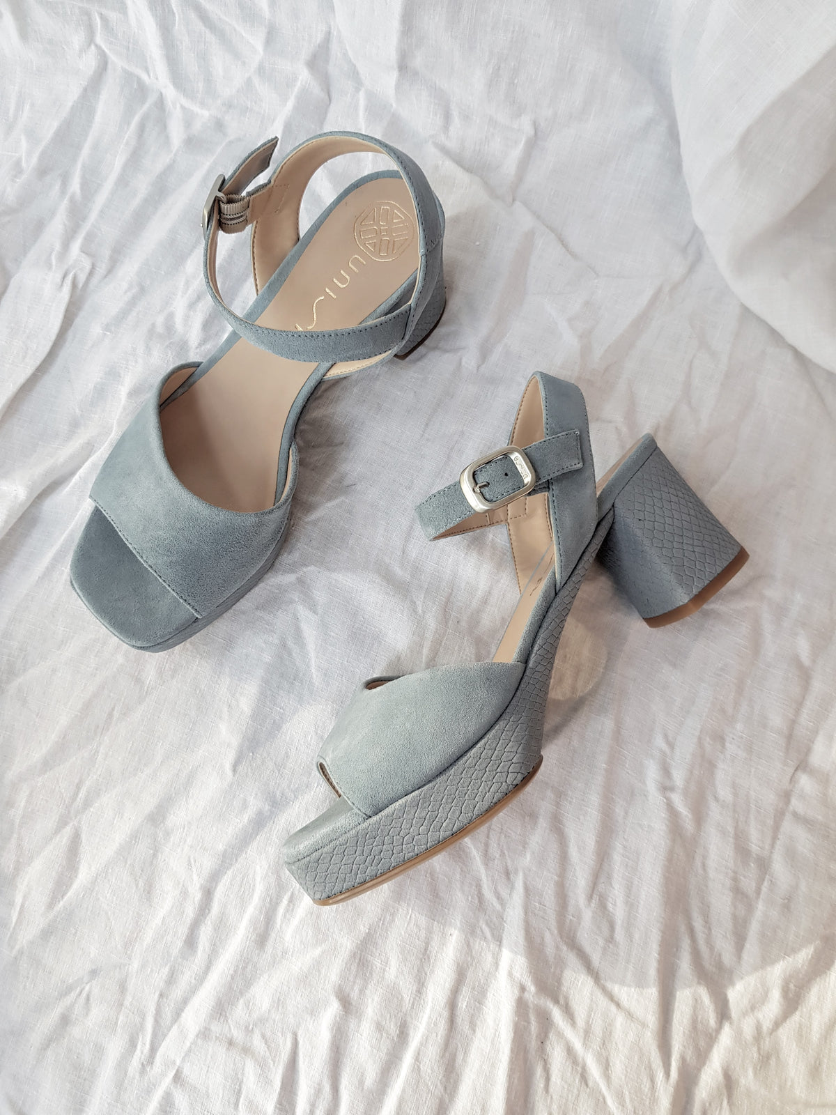 blue suede platform heels with ankle strap and silver buckle
