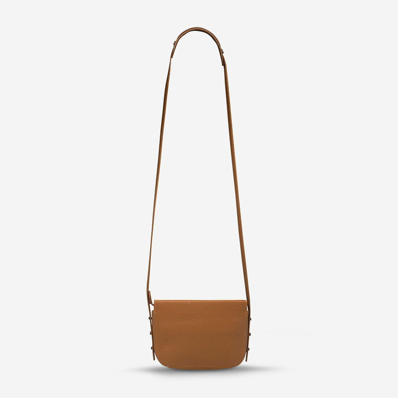 status anxiety tan leather crossbody bag in her command hunterminx back