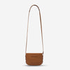 status anxiety tan leather crossbody bag in her command hunterminx