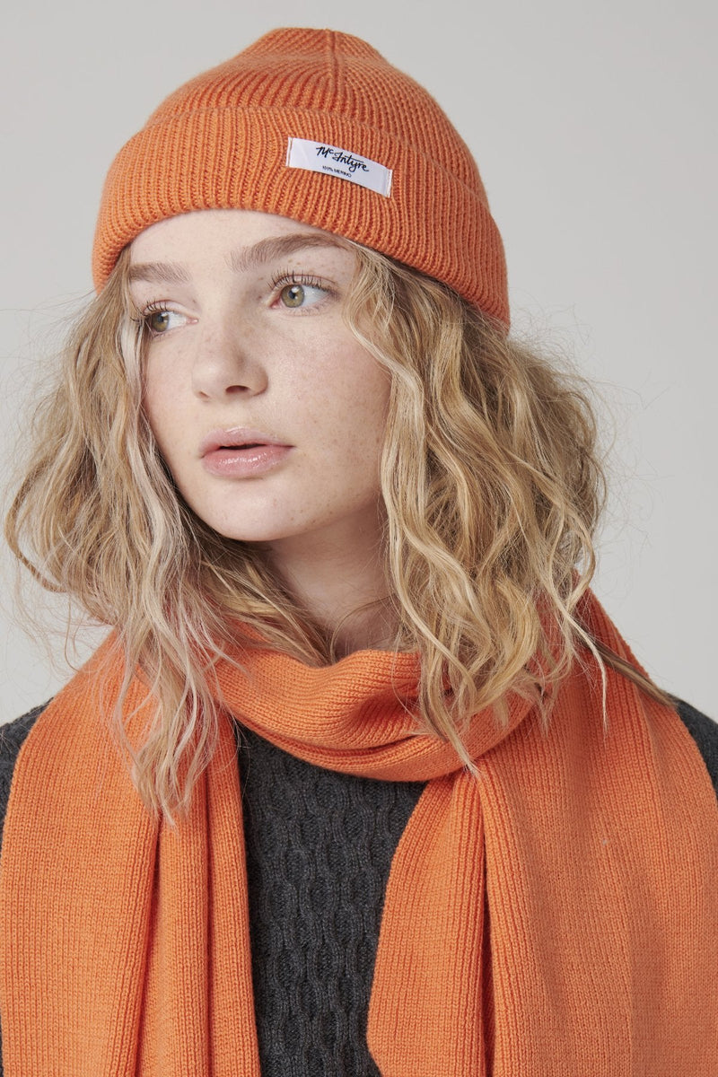 mcintyre merino unisex tabor beanie in bright orange wool modeled by girl